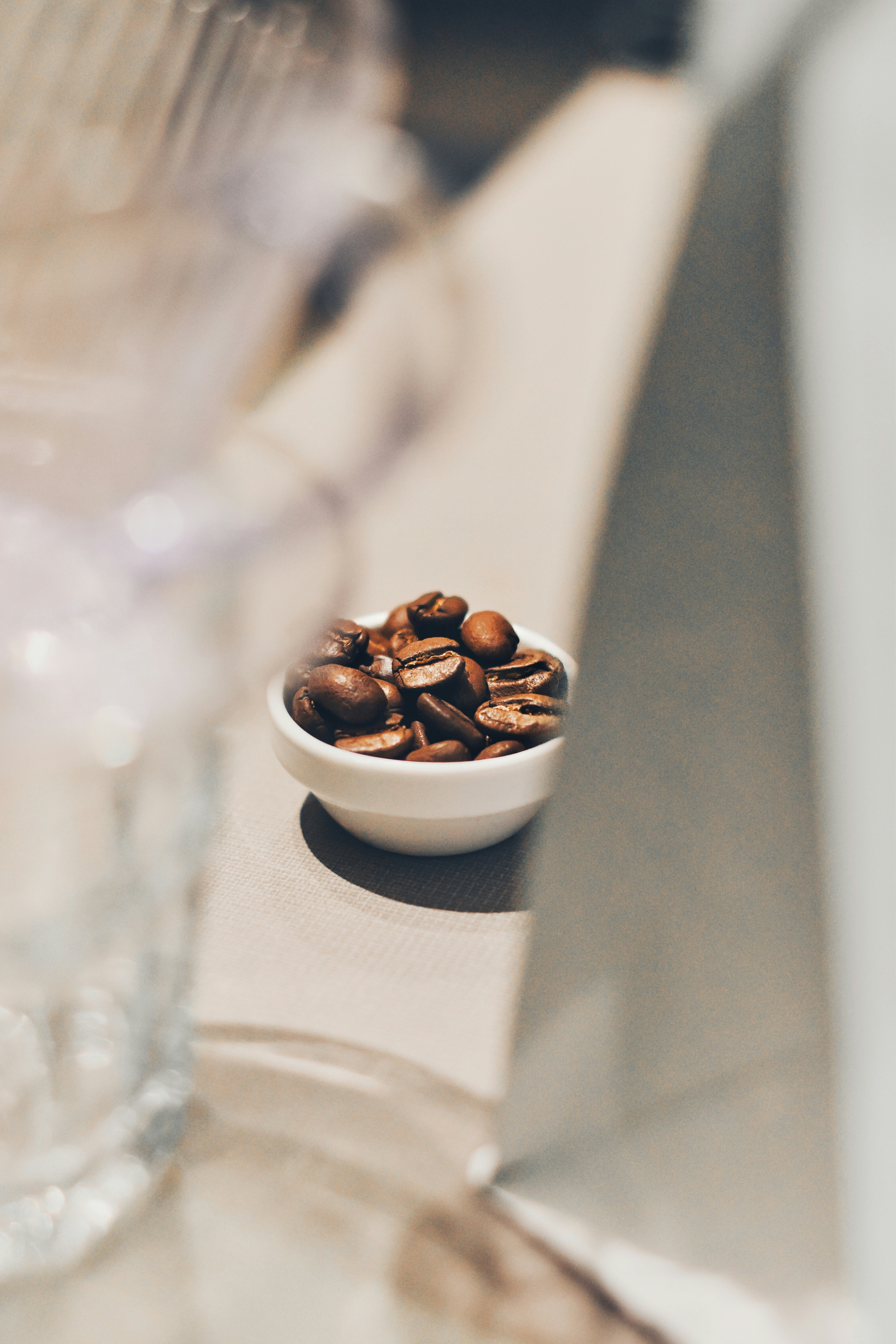 a bowl of coffee beans sitting on a table